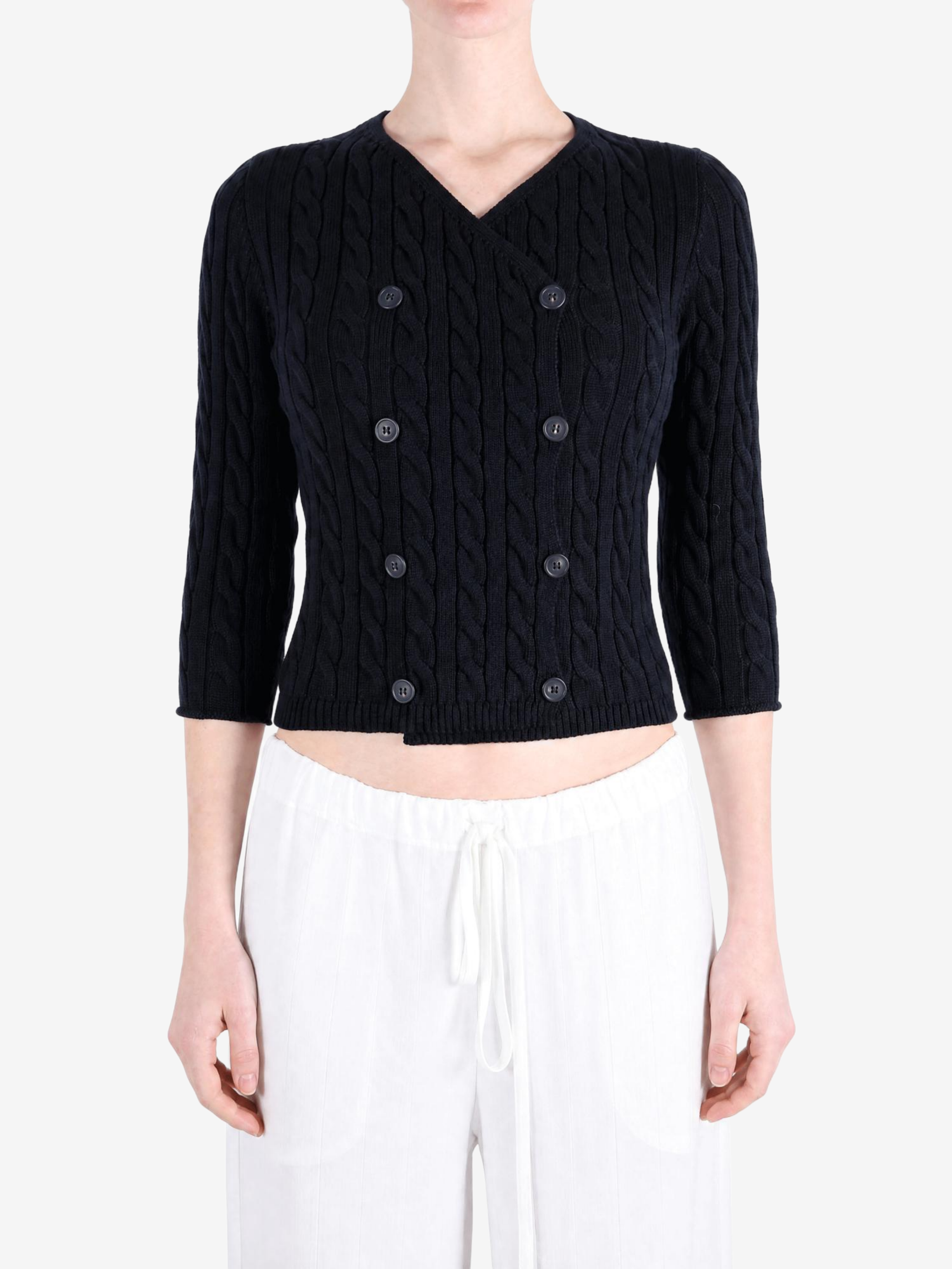 Black knitwear worn by a person, showing the knitwear fit
