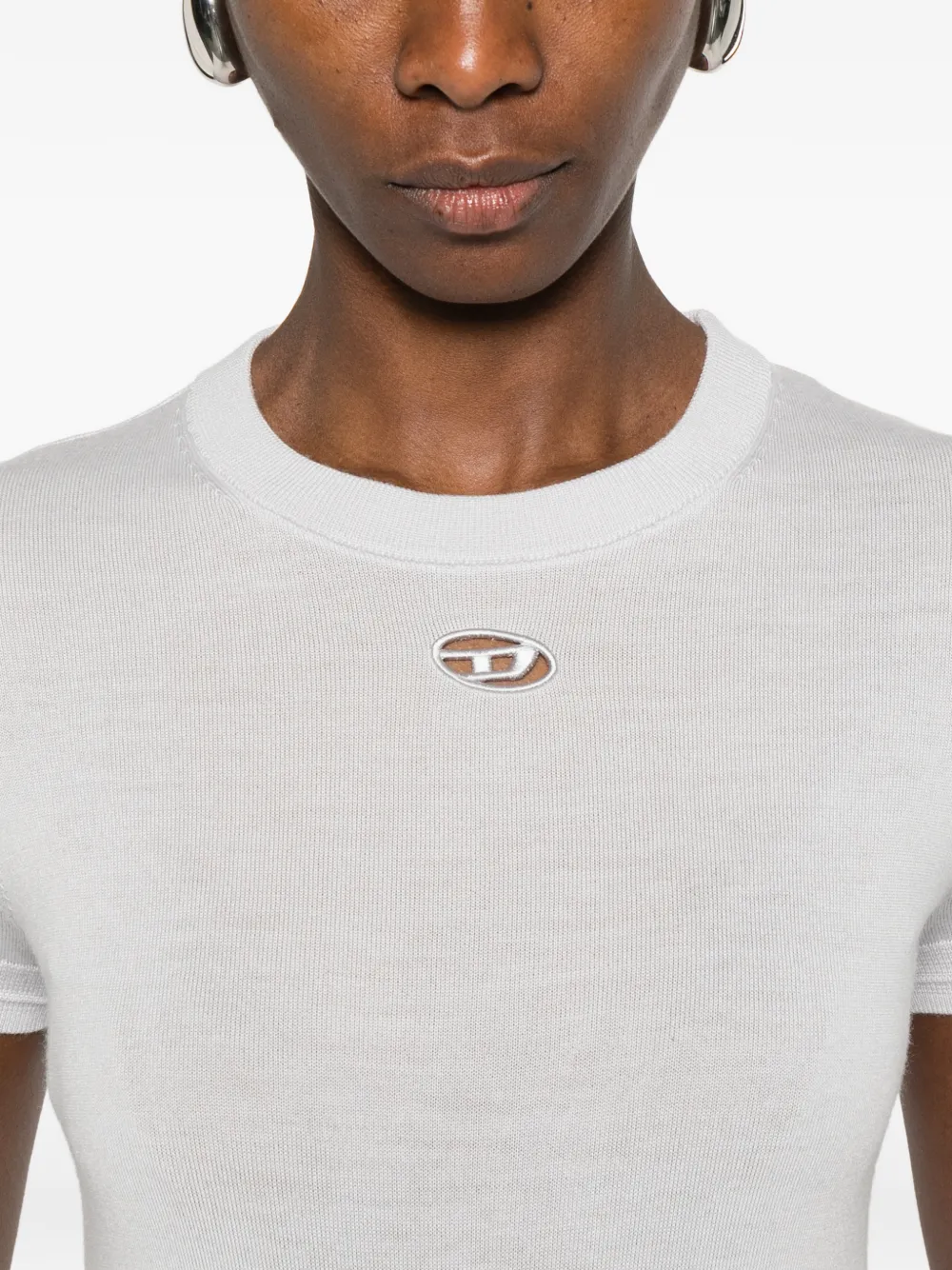 Close up of white knitwear, showing texture of the Wool fabric