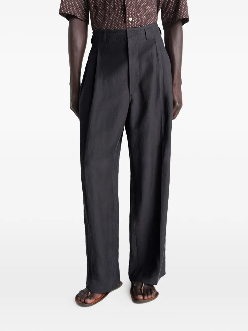 Black pants worn by a person, showing the pants fit