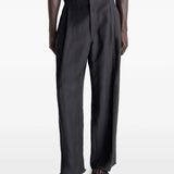 Black pants worn by a person, showing the pants fit