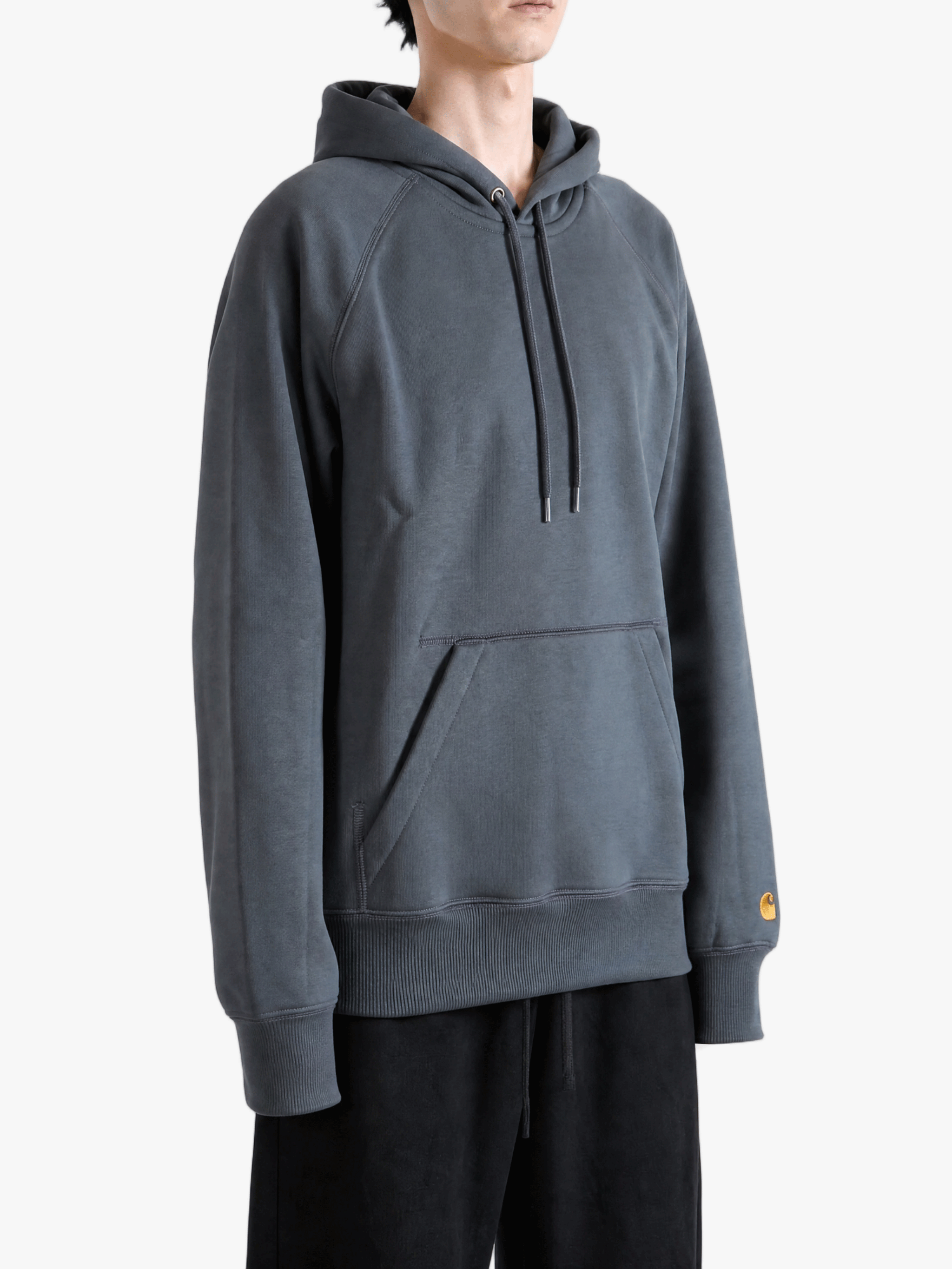 Grey hoodie worn by a person, showing the hoodie fit