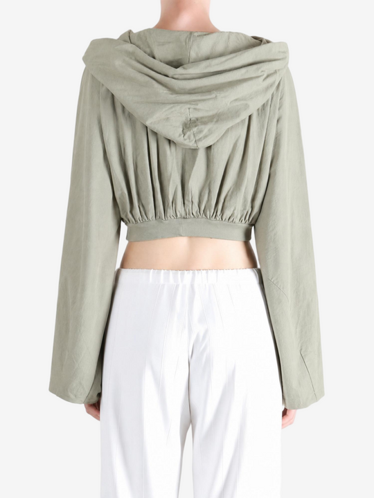 Green top worn by a person, showing the top fit
