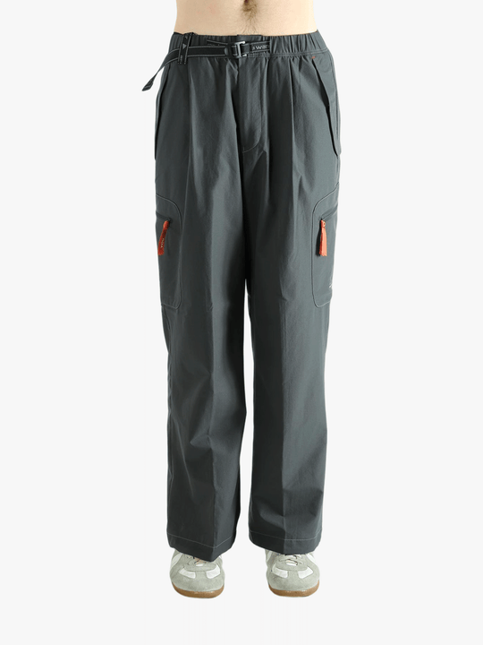 Black pants worn by a person, showing the pants's fit