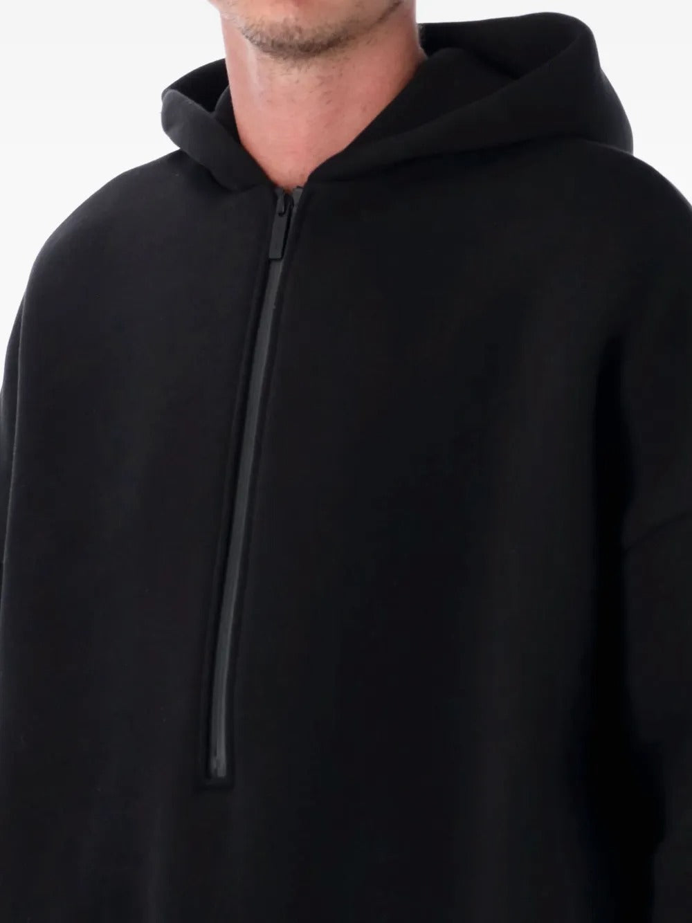 Close up of the black hoodie, showing texture of the cotton fabric