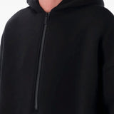 Close up of the black hoodie, showing texture of the cotton fabric