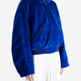 Blue jacket worn by a person, showing the jacket fit