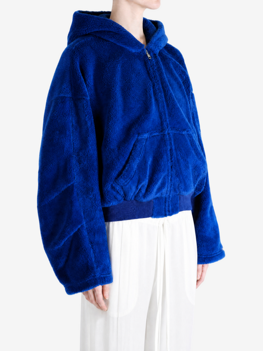 Blue jacket worn by a person, showing the jacket fit