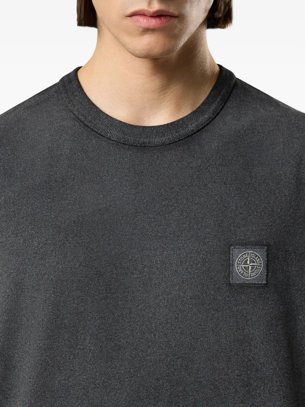 Close up of the black t-shirt, showing texture of the cotton fabric