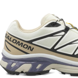 Close up of white sneakers, showing texture of the blended fabric