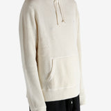 White knitwear worn by a person, showing the knitwear's fit