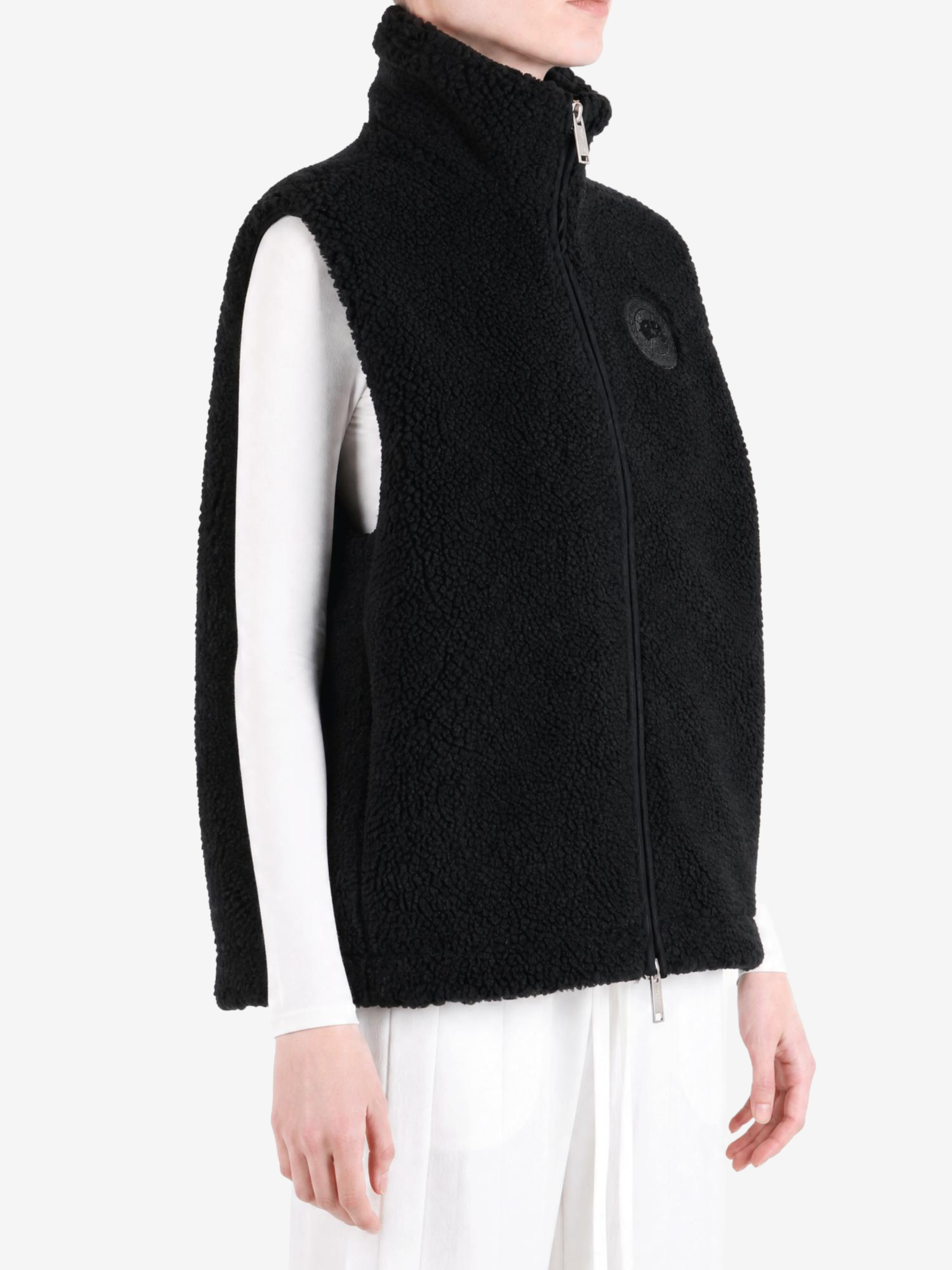 Black top worn by a person, showing the top fit