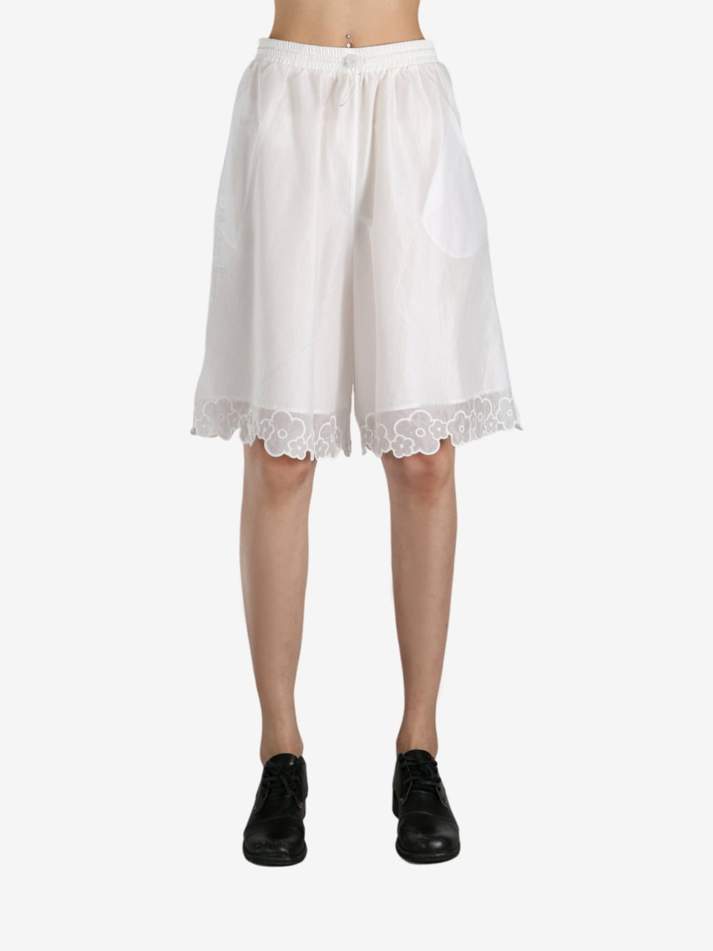 White pants worn by a person, showing the pants fit