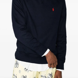 Navy knitwear worn by a person, showing the knitwear fit