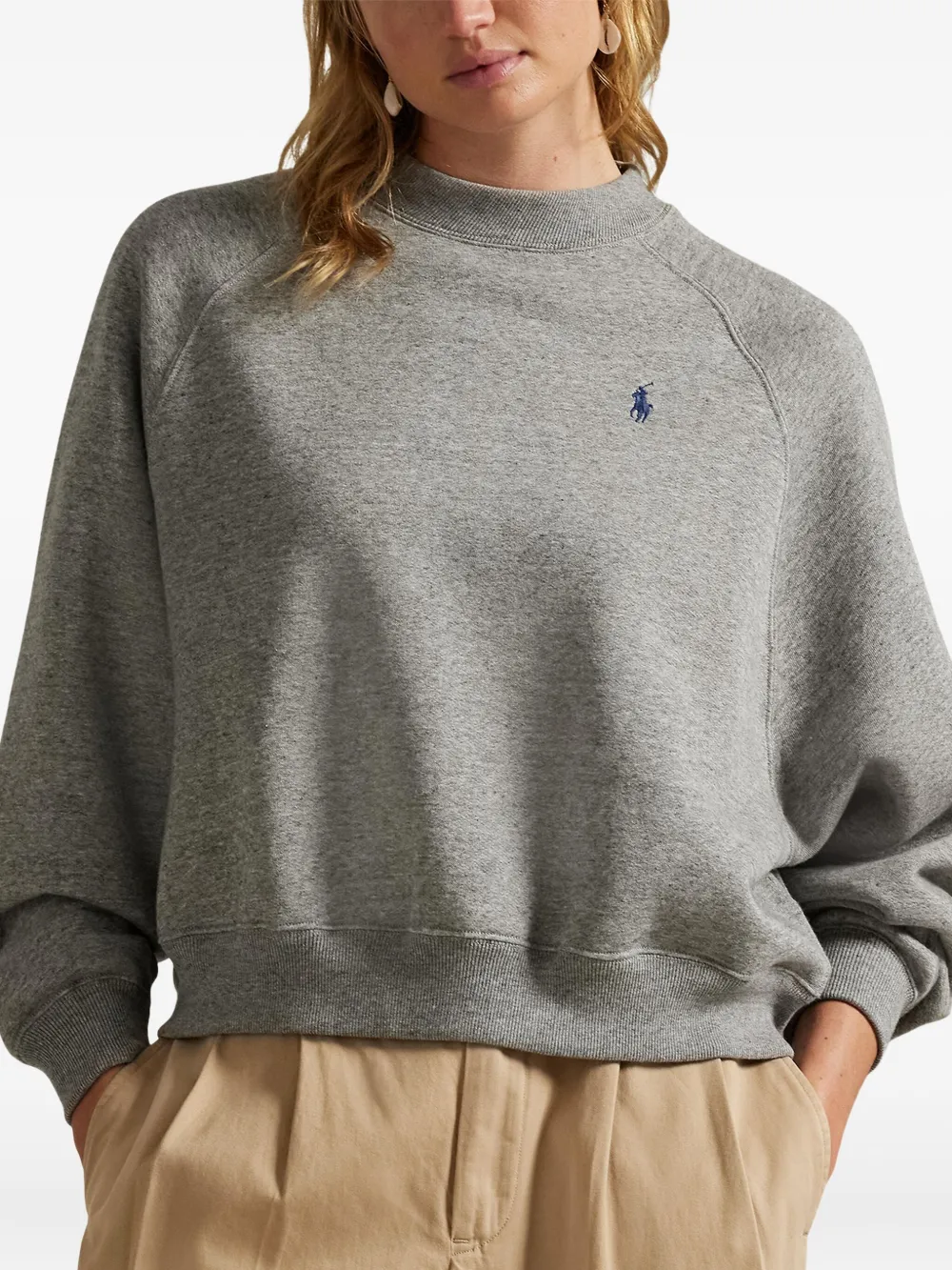 Gray sweatshirt worn by a person, showing the sweatshirt's fit