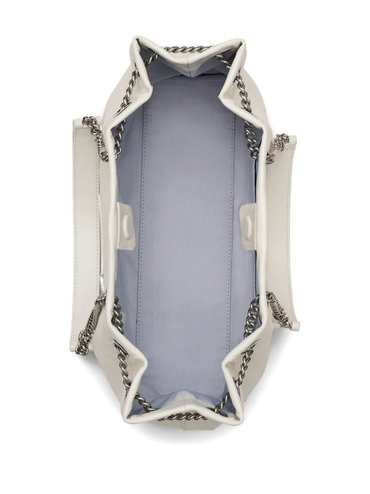 Close up of the white bag, showing texture of the leather fabric