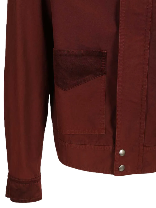 Close up of red jacket, showing the detail of flap pocket