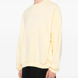 Yellow sweater worn by a person, showing the sweater fit