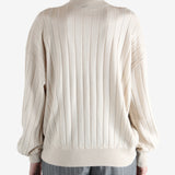 Grey knitwear worn by a person, showing the knitwear fit