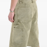 Close up of green shorts, showing texture of the Cotton fabric