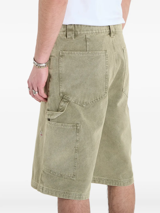 Close up of green shorts, showing texture of the Cotton fabric
