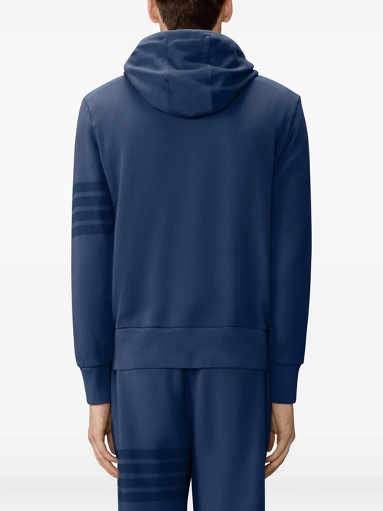 navy hoodie worn by a person, showing the hoodie fit