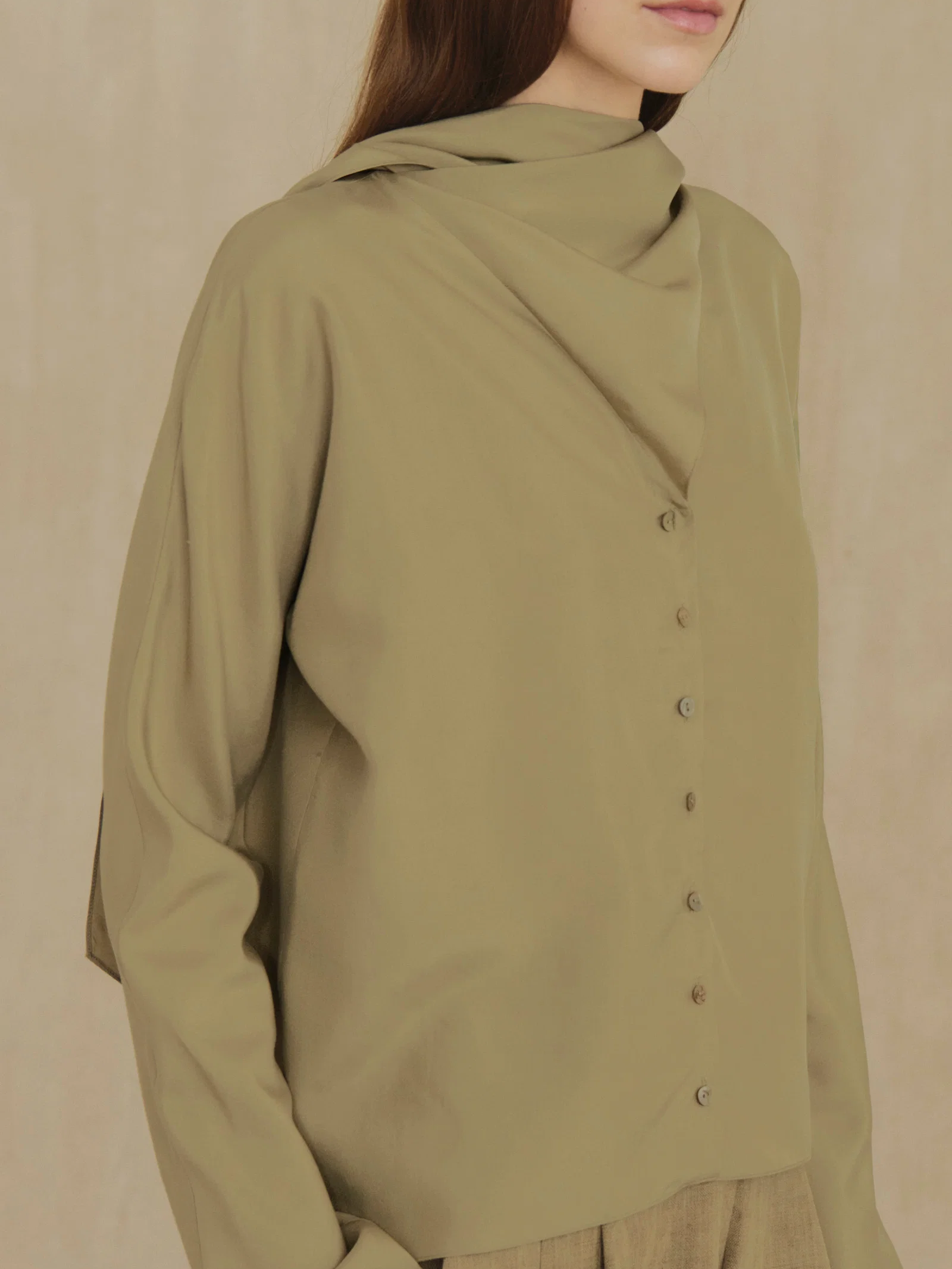 Green shirt worn by a person, showing the shirt fit