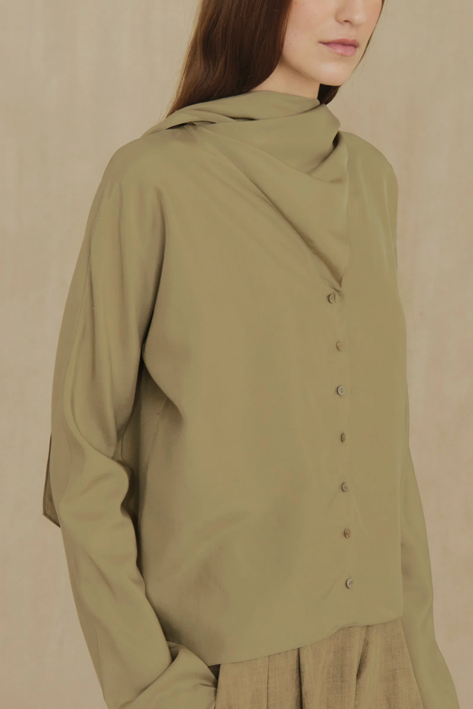 Green shirt worn by a person, showing the shirt fit