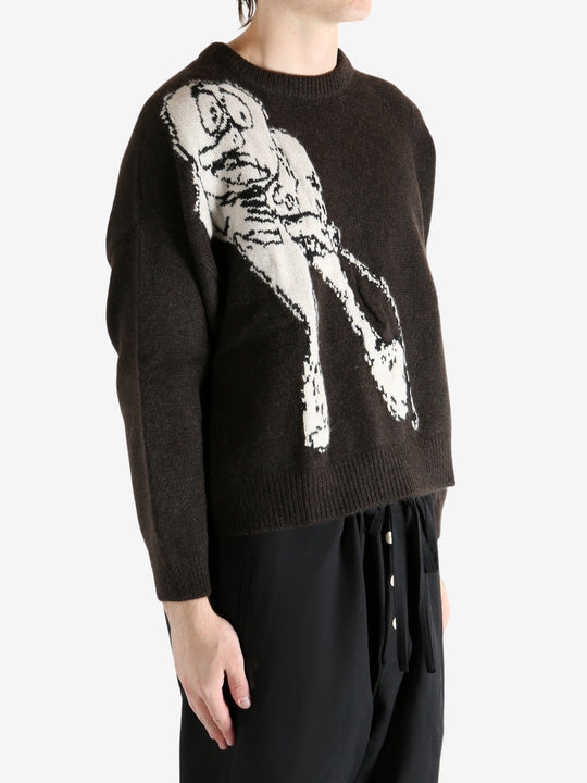 Black sweater worn by a person, showing the sweater's fit