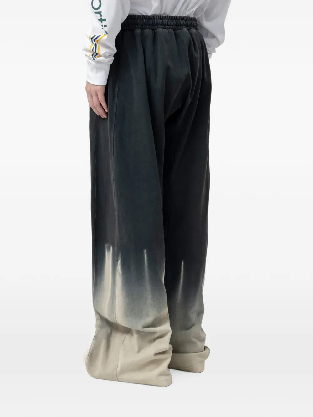 Black jeans worn by a person, showing the jeans fit
