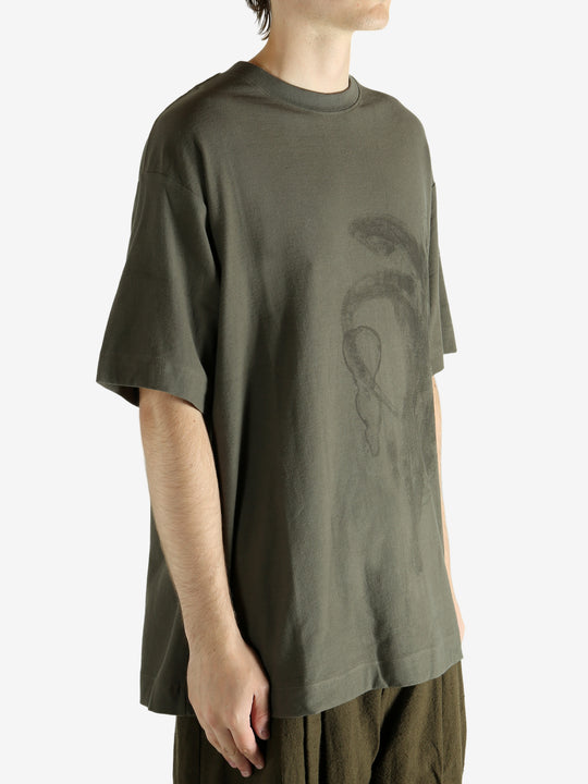 Green t-shirt worn by a person, showing the t-shirt's fit