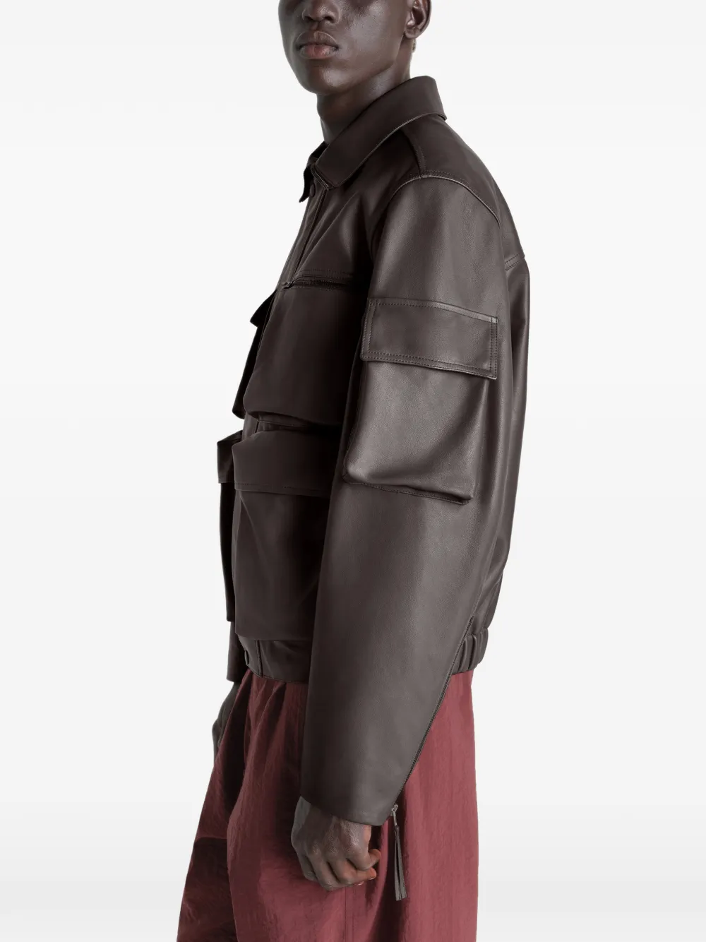 Brown coats worn by a person, showing the coats fit