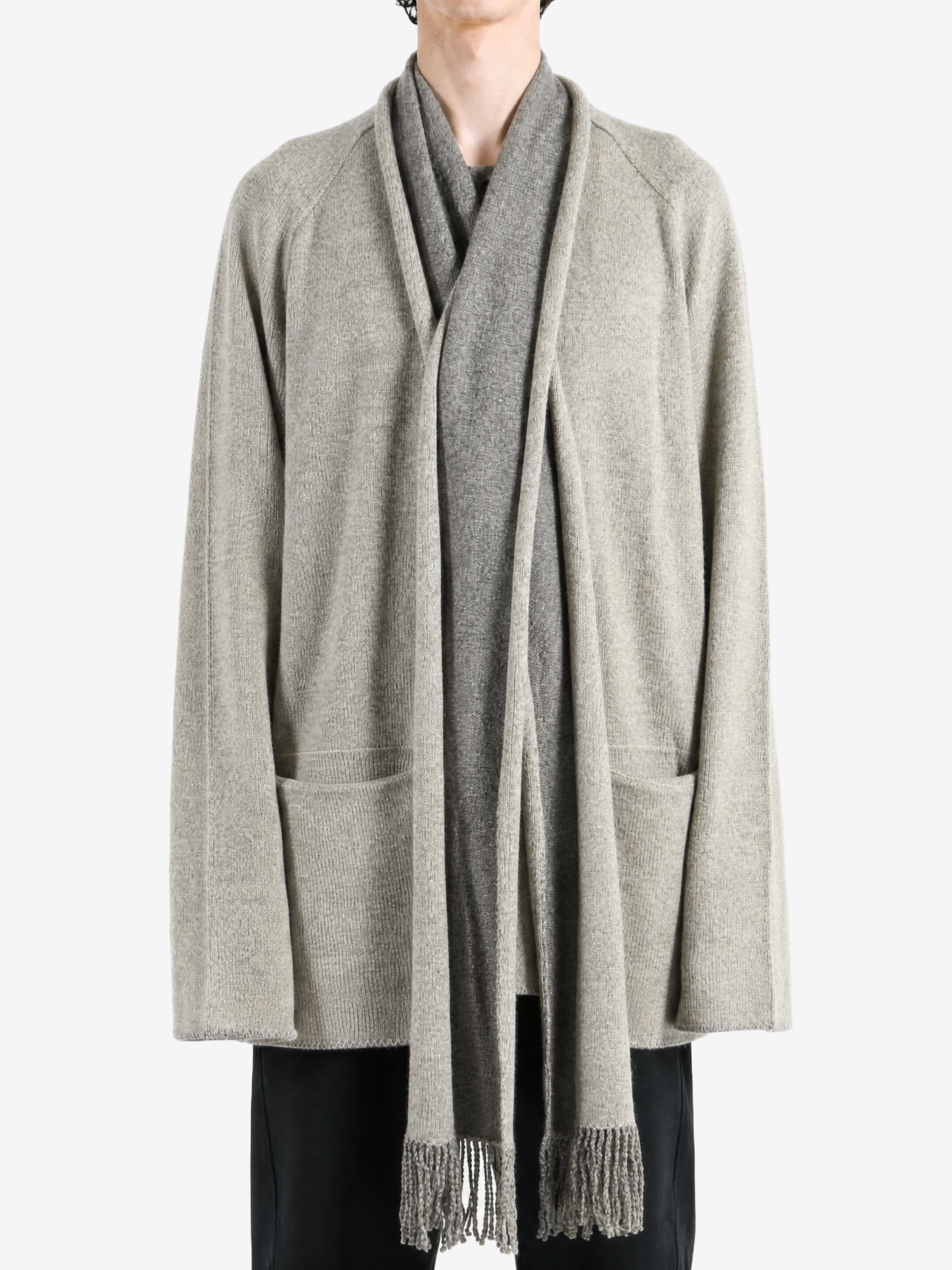 Grey knitwear worn by a person, showing the knitwear fit