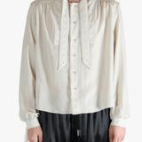 White shirt worn by a person, showing the shirt's fit
