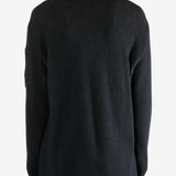 Black sweater worn by a person, showing the sweater fit