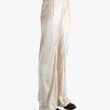 White pants worn by a person, showing the pant's fit