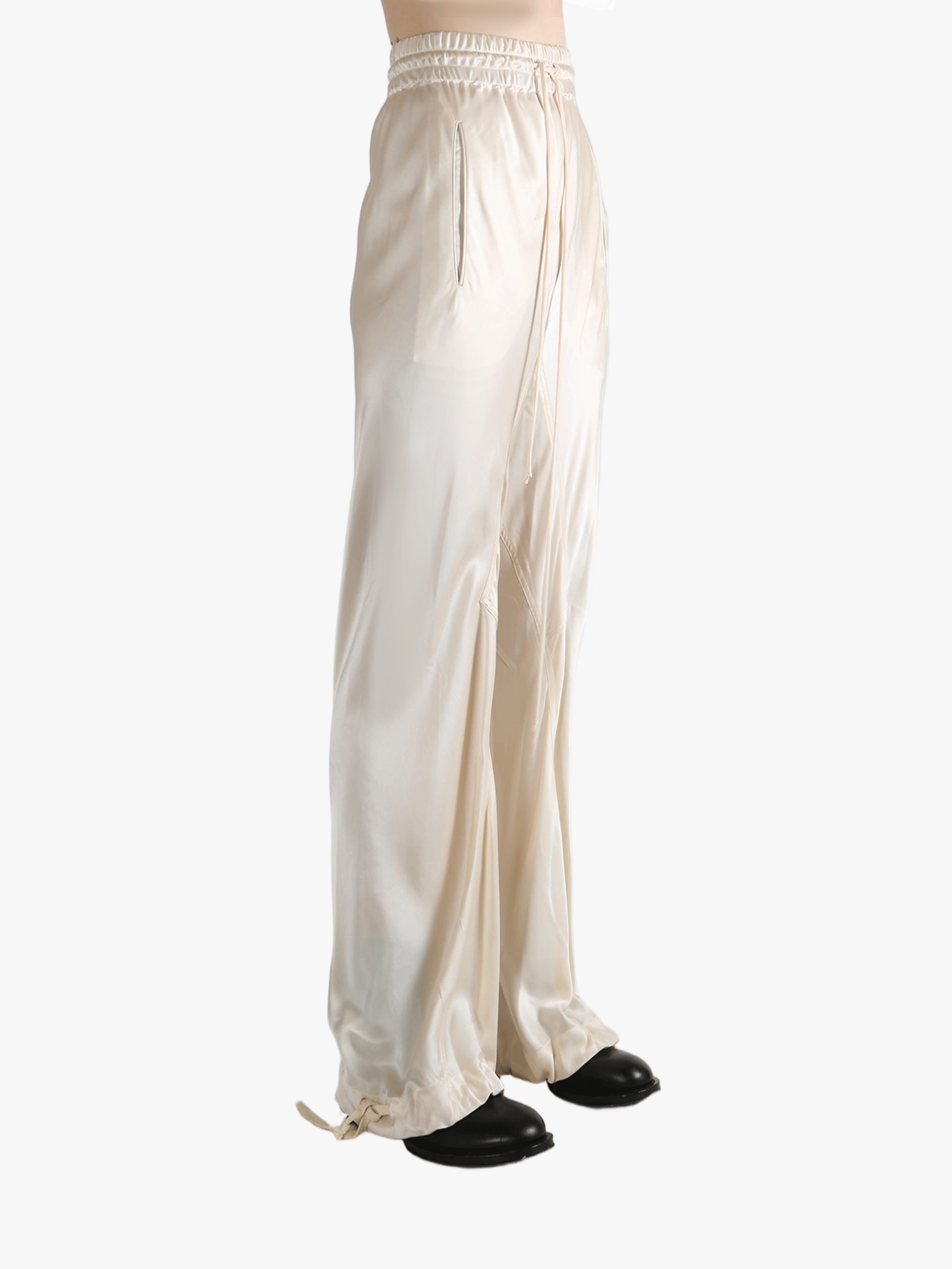 White pants worn by a person, showing the pant's fit