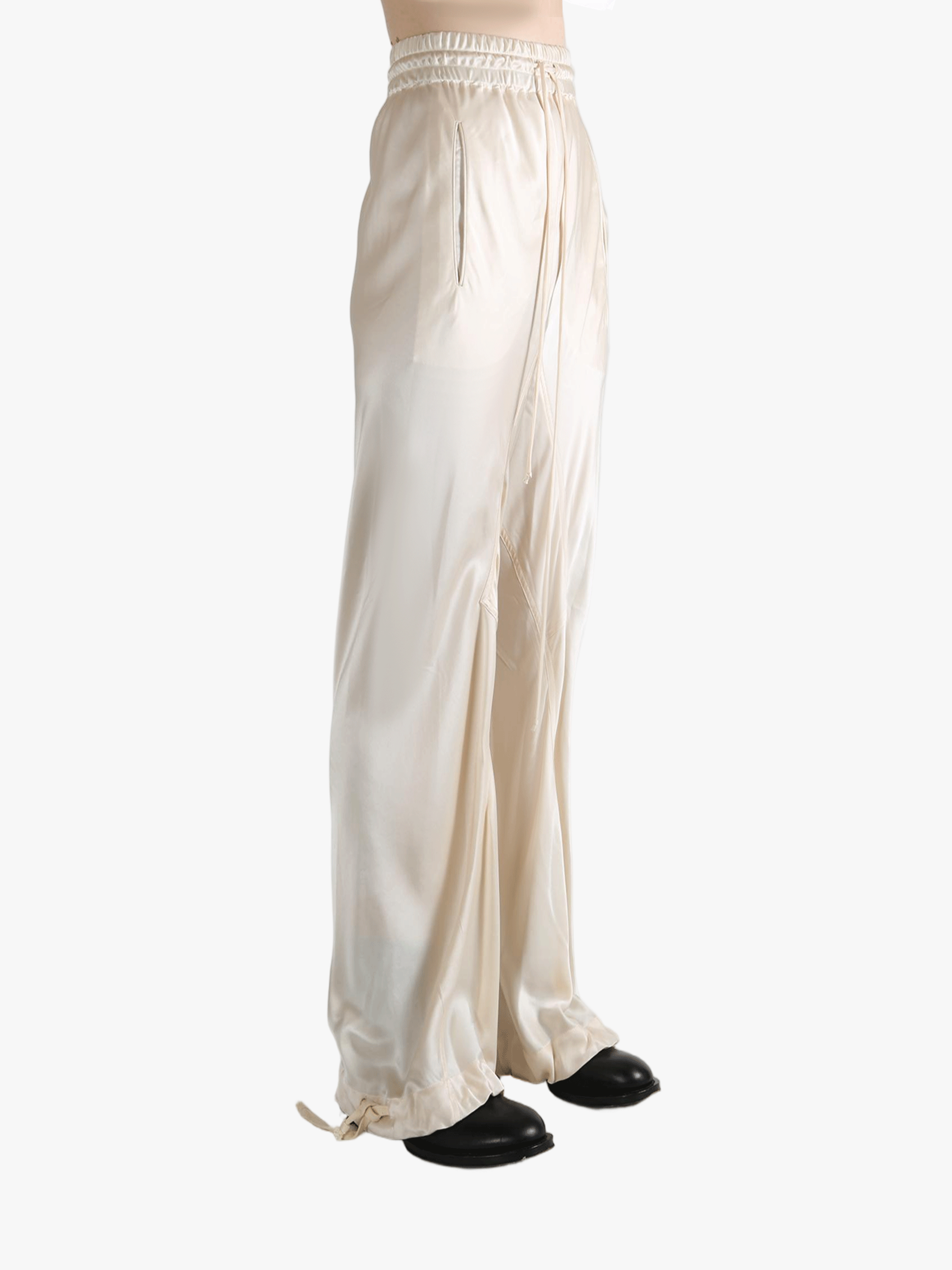 White pants worn by a person, showing the pant's fit