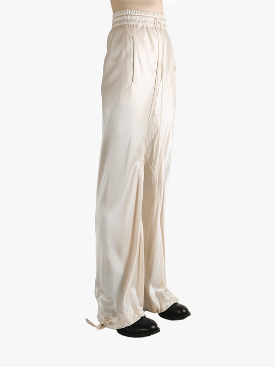 White pants worn by a person, showing the pant's fit