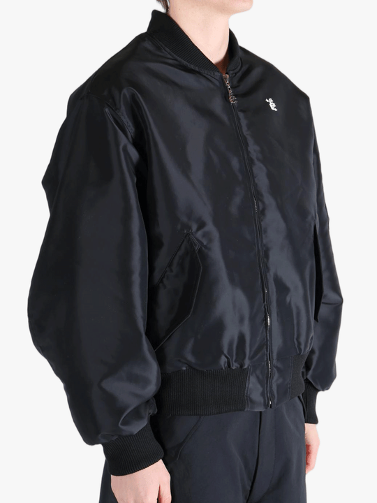 Black jackets-coat worn by a person, showing the jackets-coat's fit