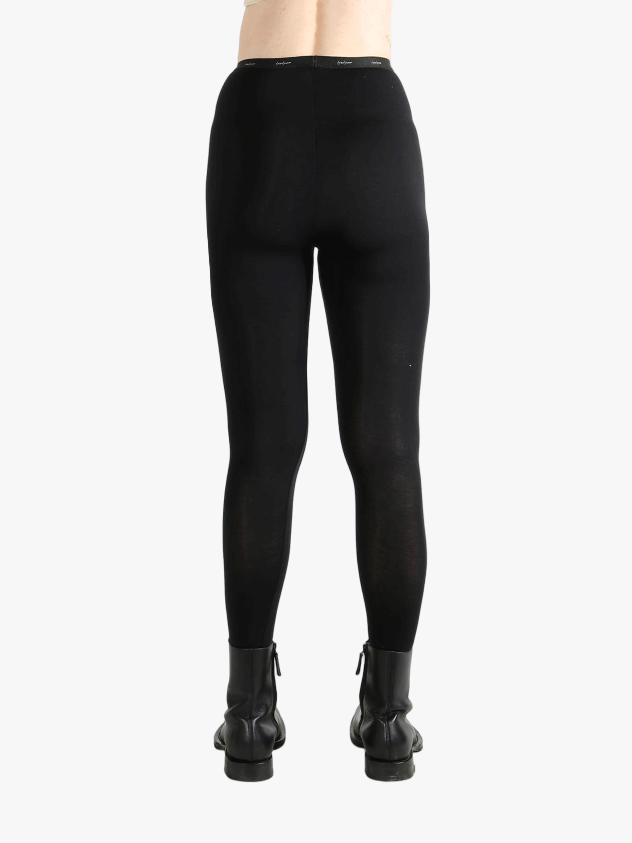 Black pants worn by a person, showing the pants fit