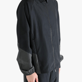 Black jacket worn by a person, showing the jacket's fit