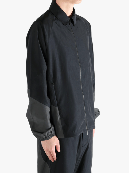 Black jacket worn by a person, showing the jacket's fit