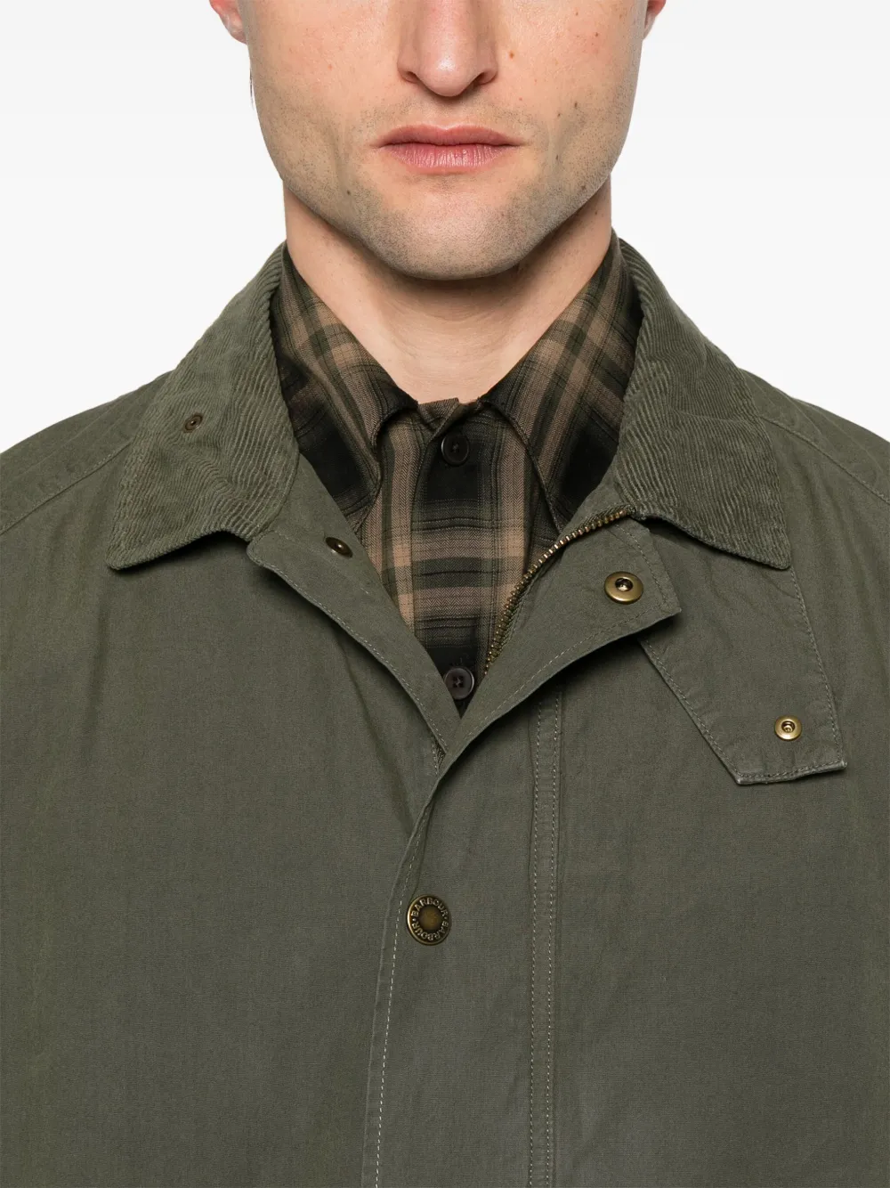 Close up of green jacket, showing texture of the cotton fabric
