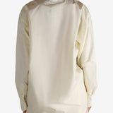 White shirt worn by a person, showing the shirt's fit