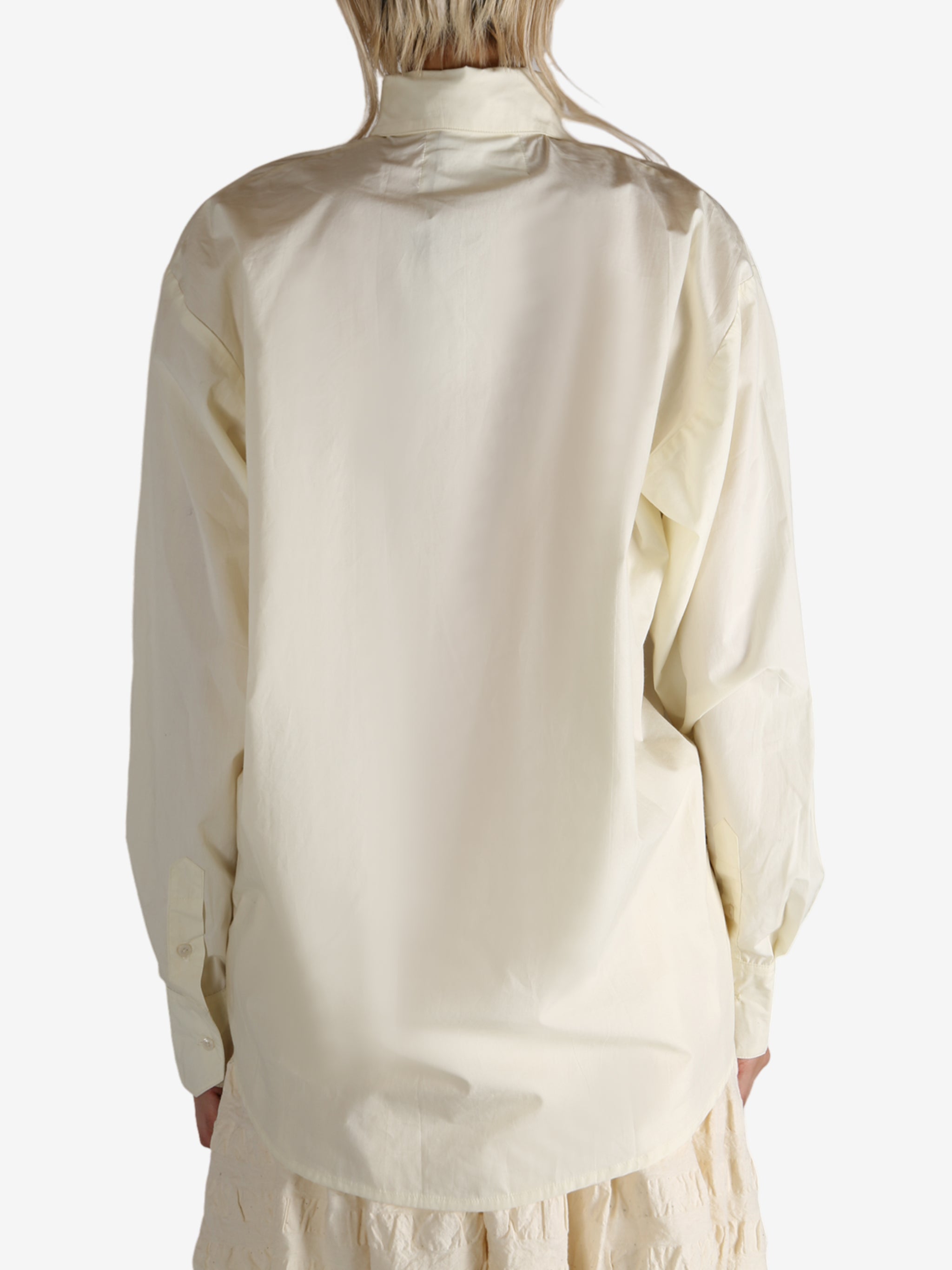 White shirt worn by a person, showing the shirt's fit