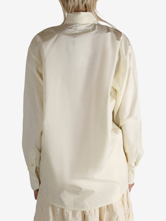 White shirt worn by a person, showing the shirt's fit