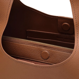 close up of brown bags, showing texture of the leather fabric