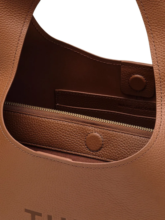 close up of brown bags, showing texture of the leather fabric