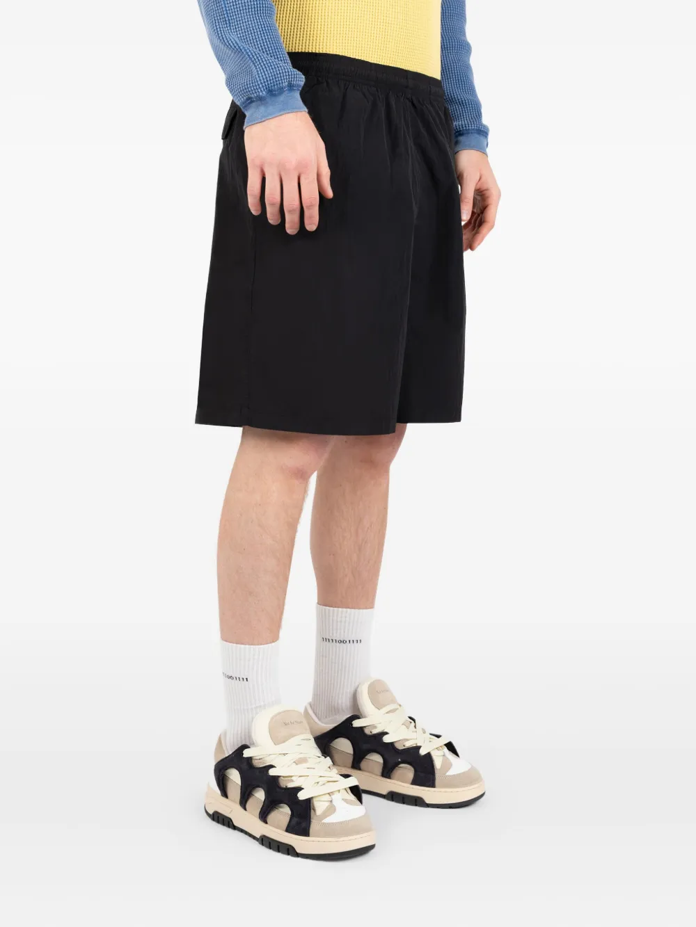 Black shorts worn by a person, showing the shorts fit