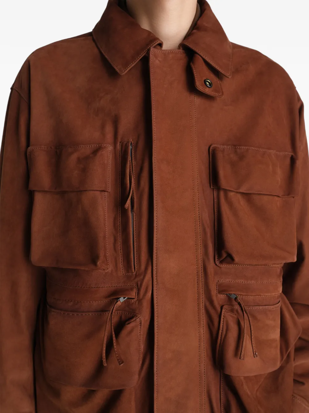 Close up of brown jackets-coats, showing texture of the cotton fabric